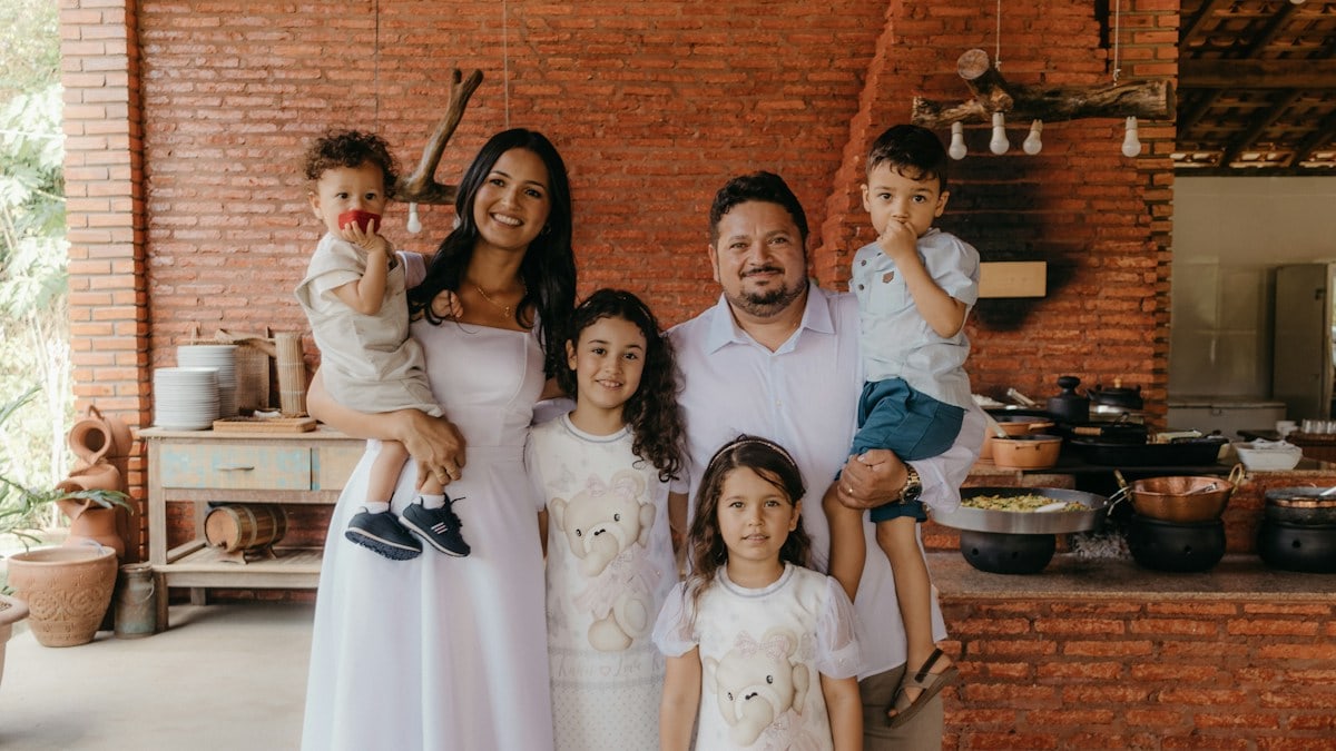 a family posing for a picture in a kitchen